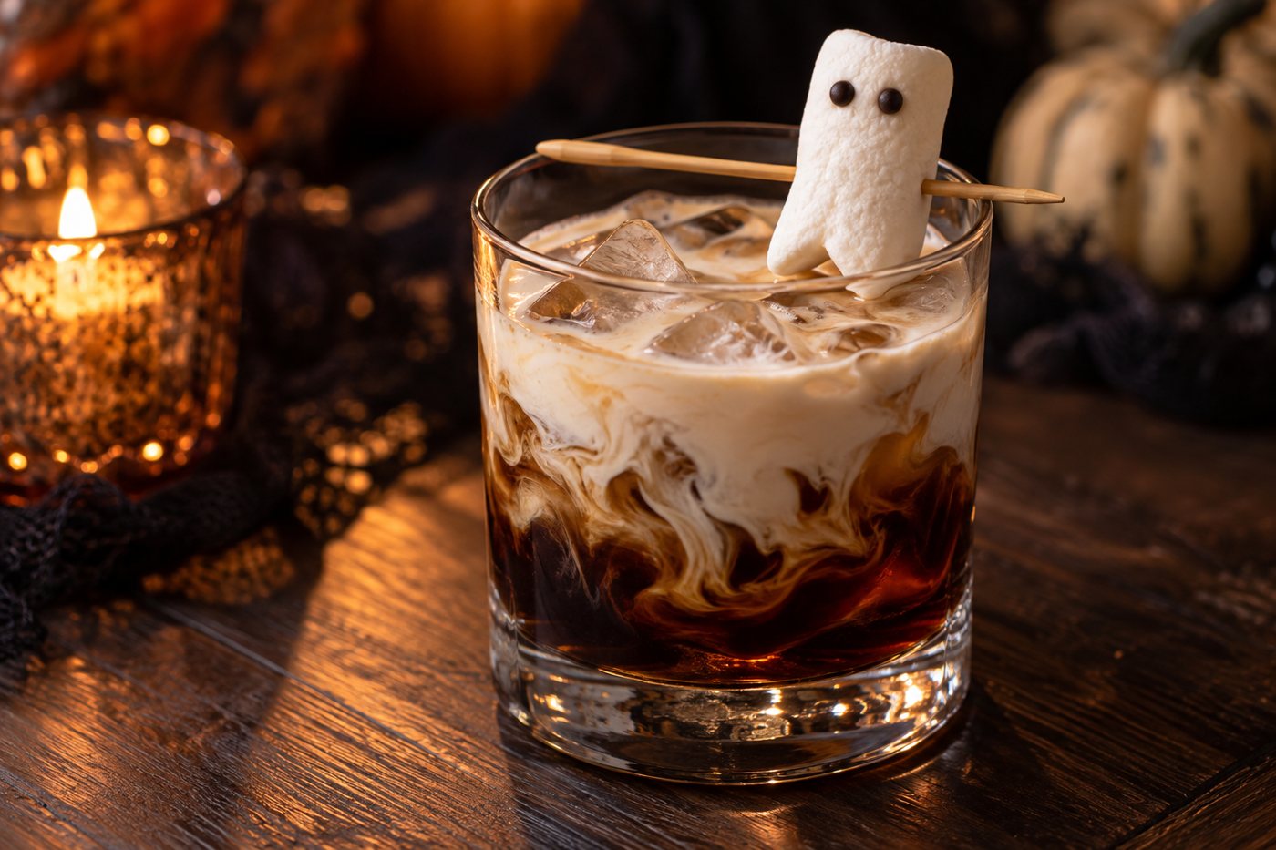 Cream swirling through a White Russian with a chocolate-eyed marshmallow ghost on a pick across the rim