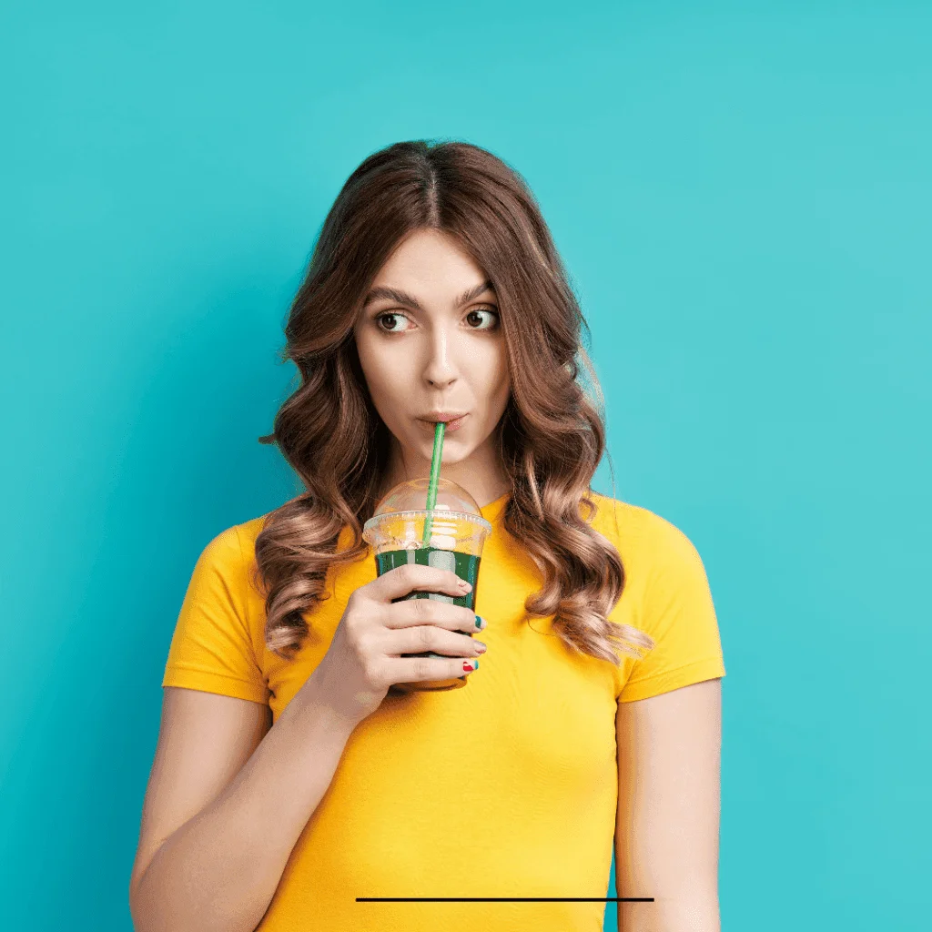A woman drinking Dutch Bros Rebel