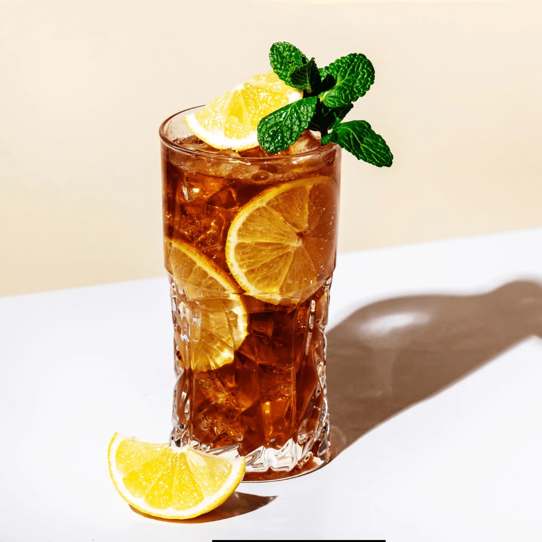 Refreshing Tea Bag Cocktail served with lemon slices and mint.