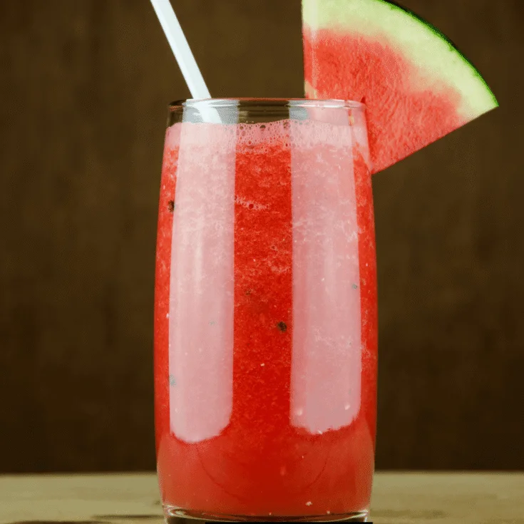 Smoothie King Watermelon Xtreme Drink with a watermelon slice on a beach