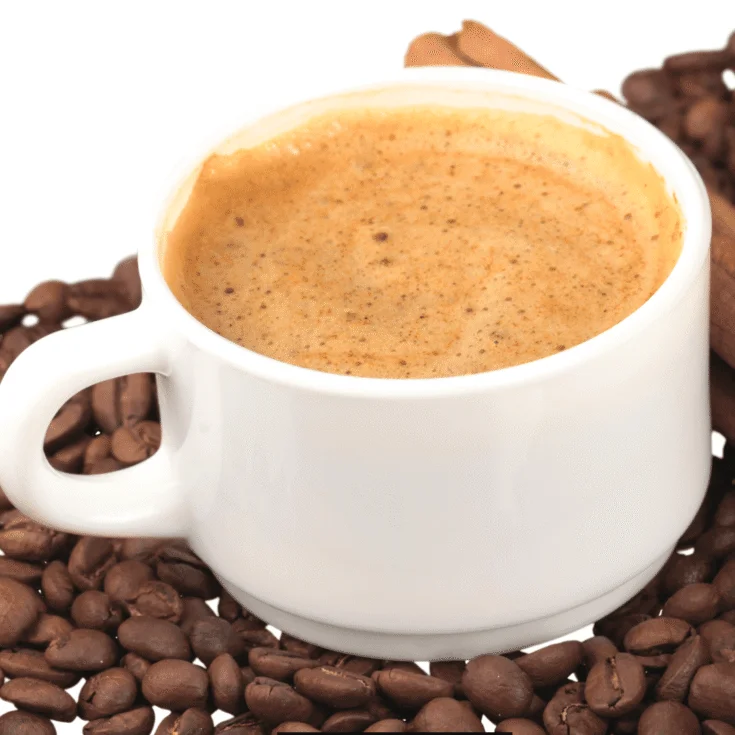 Warm Copycat Dunkin' Almond Spice Coffee served in a pile of coffee beans