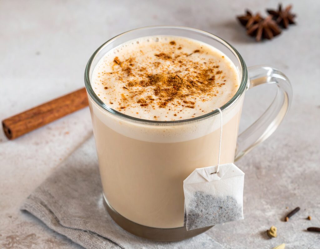 Spiced up chai latte with a tea bag with some spice garnished on top
